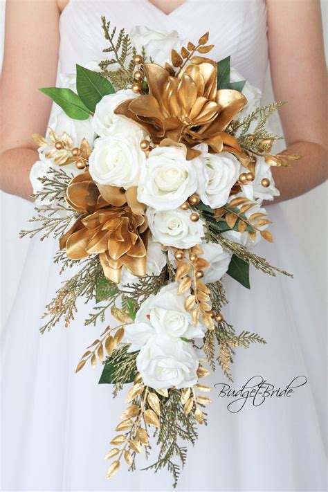 gold and white wedding bouquets|white and gold floral arrangements.